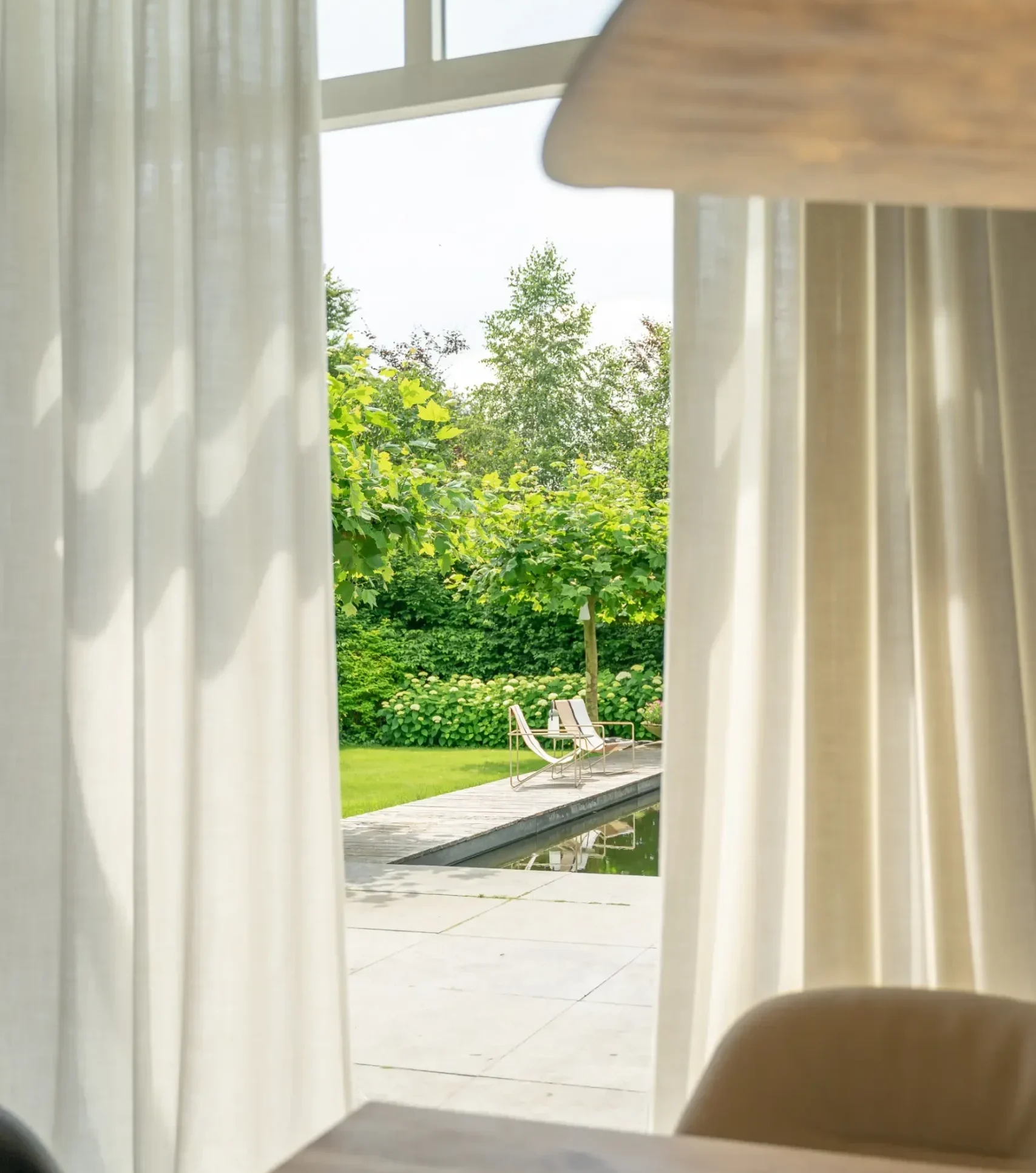 Prachtige hangende gordijnen met opening naar groene tuin